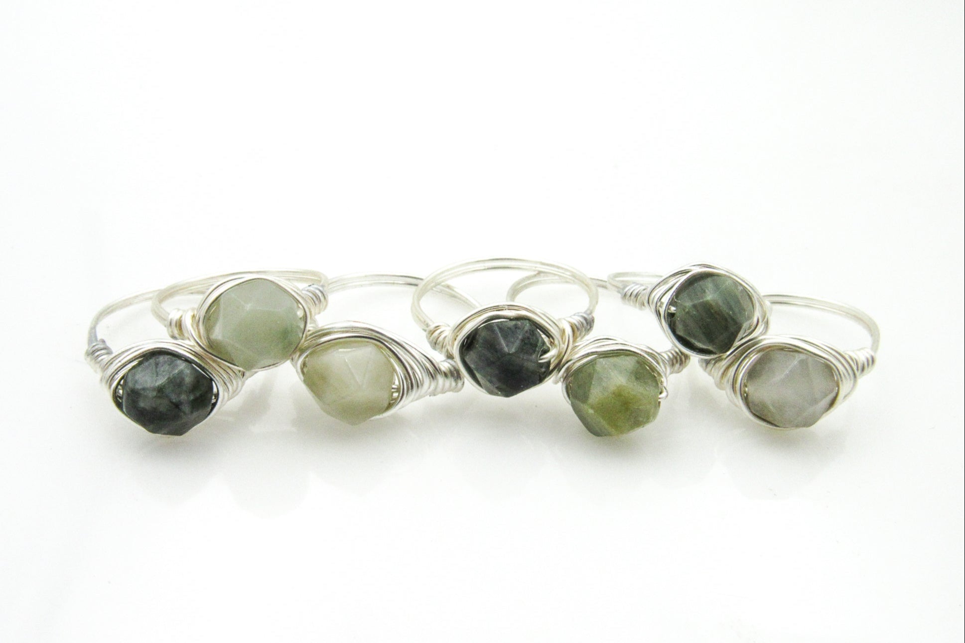 Green jade faceted beads in a silver wire wrapped ring